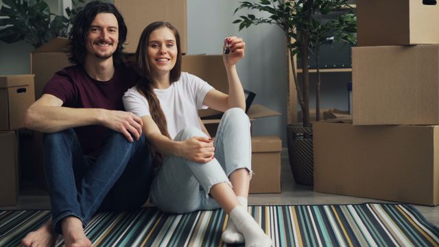 A couple holding the keys to their new property